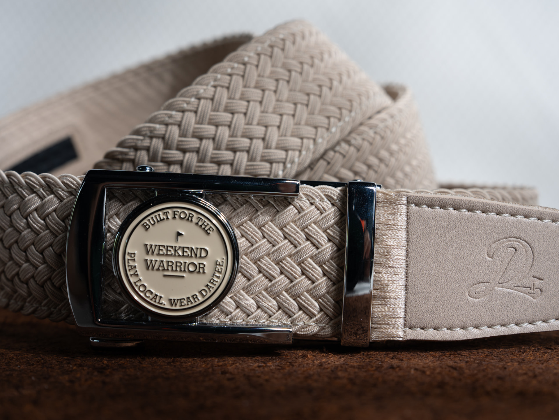 Cream woven Dartee Muni Collection belt with a Weekend Warrior ball marker locked into the buckle